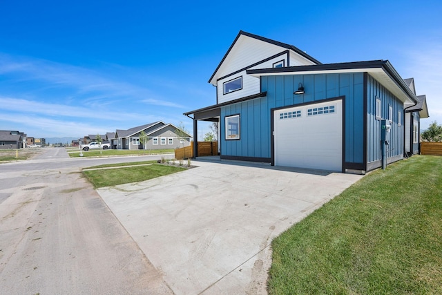 590 Stillwater Rd, Kalispell, MT 59901 - view of front of house with board and batten siding, a garage, and concrete driveway