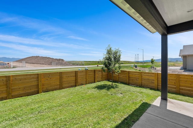 590 Stillwater Rd, Kalispell, MT 59901 - fenced backyard featuring a mountain view and a patio
