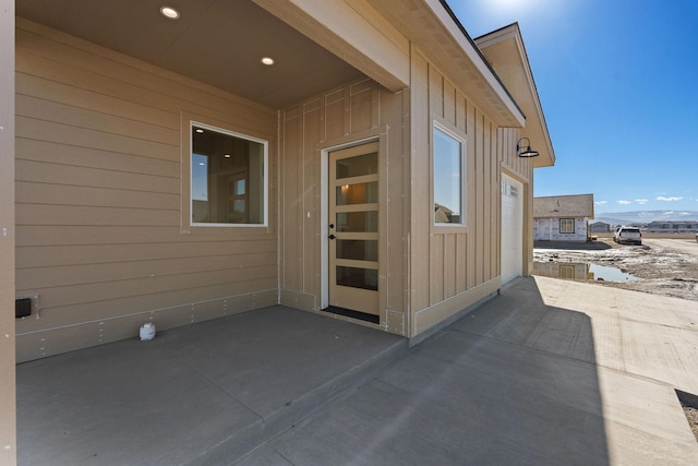 doorway to property with a patio and board and batten siding