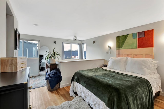 bedroom featuring light wood-type flooring and baseboards