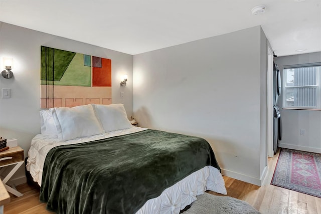 bedroom featuring baseboards and wood finished floors