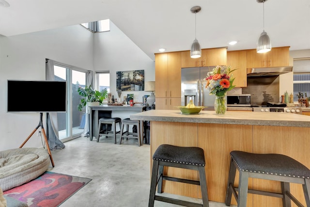 kitchen with a breakfast bar, finished concrete flooring, stainless steel appliances, light countertops, and decorative backsplash