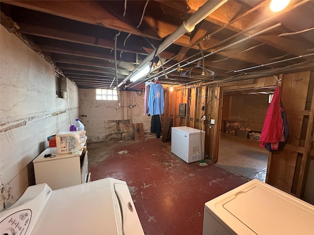 below grade area featuring washer and clothes dryer and fridge