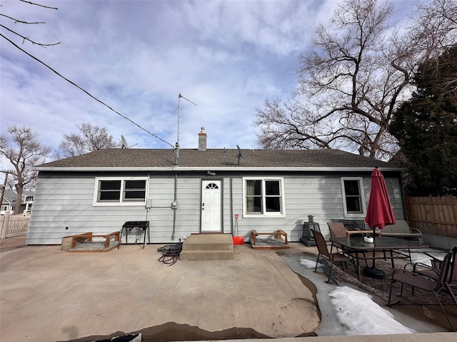 rear view of property with a patio area, a chimney, and fence