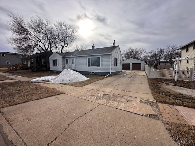 view of front of home featuring a garage, an outdoor structure, a chimney, and fence