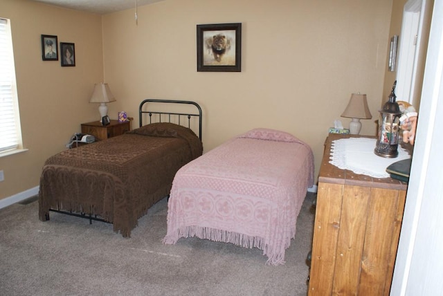 bedroom featuring carpet and baseboards