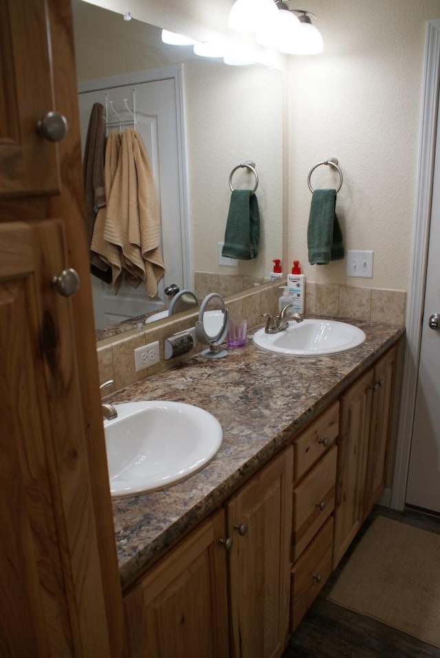 bathroom with a sink and double vanity