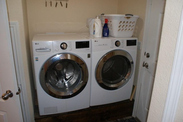 washroom featuring laundry area and separate washer and dryer