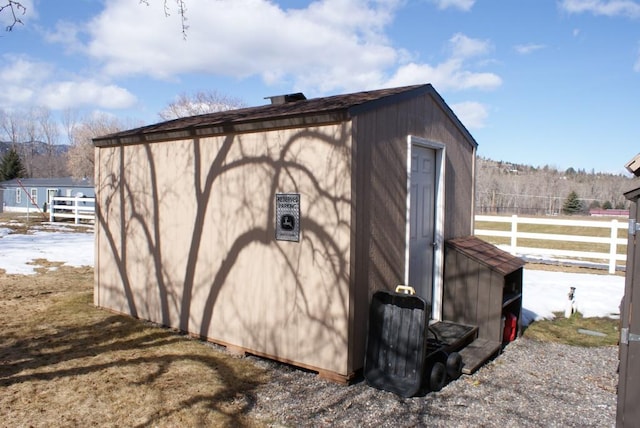 view of outdoor structure with an outbuilding and fence