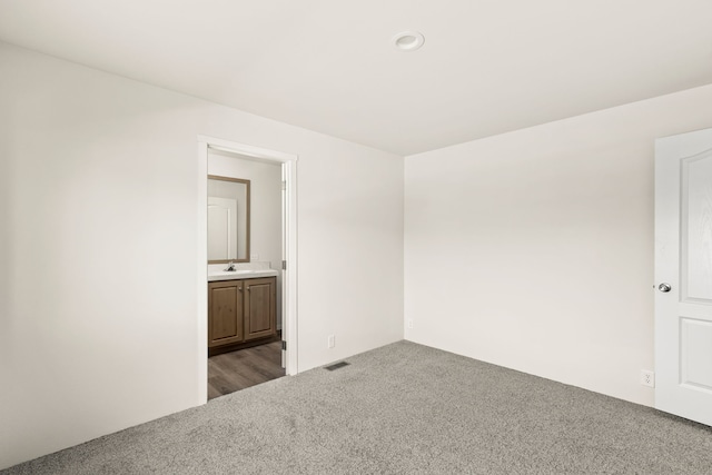 spare room with carpet floors and a sink