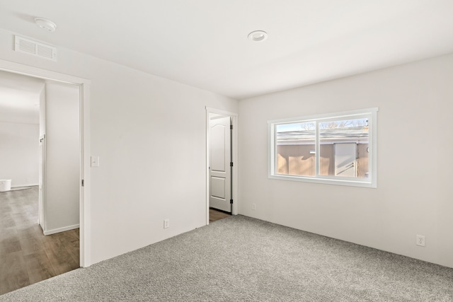 carpeted spare room with visible vents