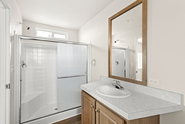 bathroom featuring a shower stall and vanity