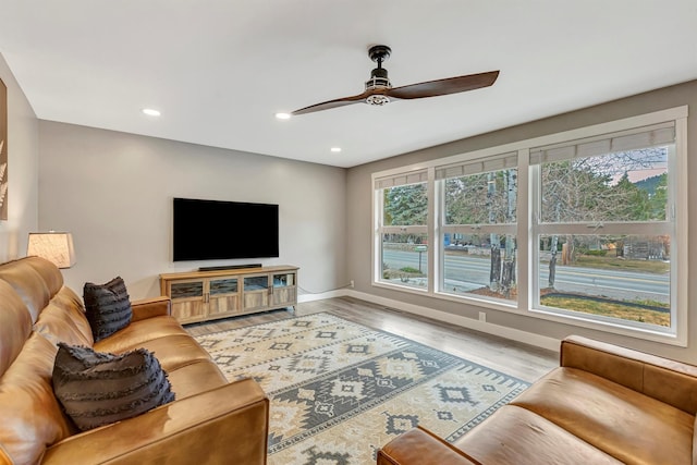 living room featuring recessed lighting, baseboards, wood finished floors, and a ceiling fan