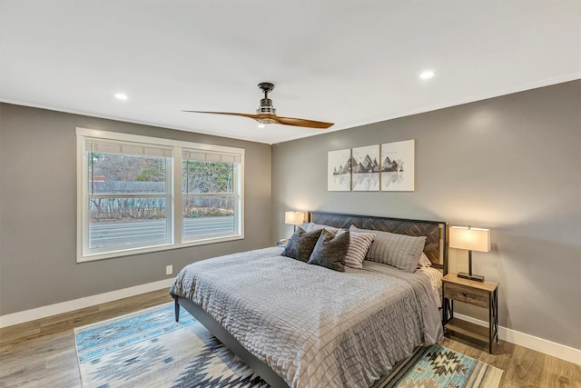 bedroom with ceiling fan, baseboards, wood finished floors, and recessed lighting