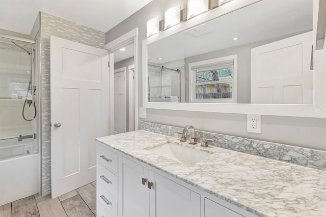 bathroom featuring vanity, combined bath / shower with glass door, and wood finish floors