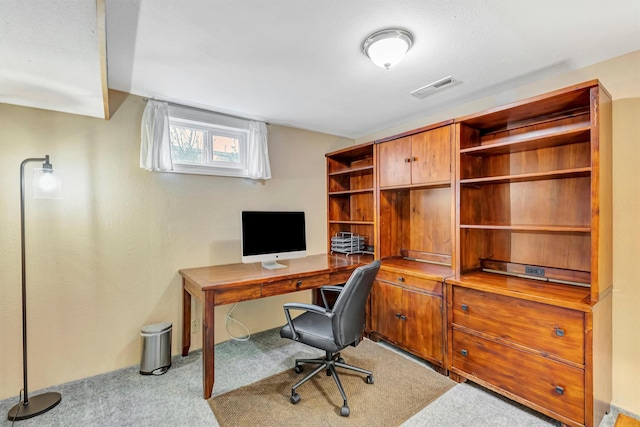 carpeted office space featuring visible vents