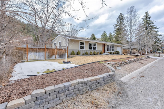 single story home featuring fence