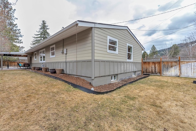 view of property exterior featuring a patio, a yard, and fence