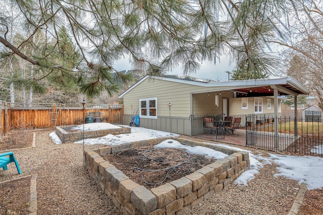 back of house featuring a patio area and a fenced backyard