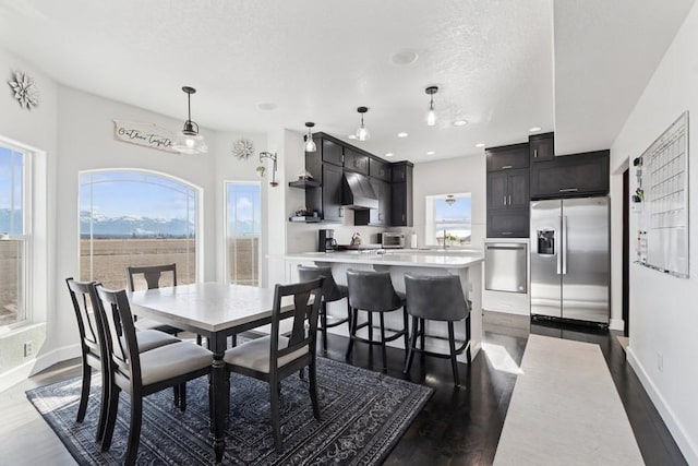 dining space featuring recessed lighting, baseboards, and dark wood-style floors