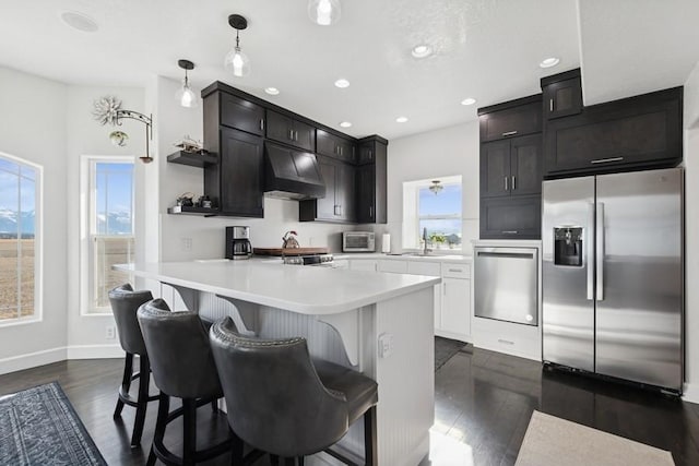 kitchen with custom exhaust hood, open shelves, stainless steel appliances, light countertops, and dark wood-type flooring