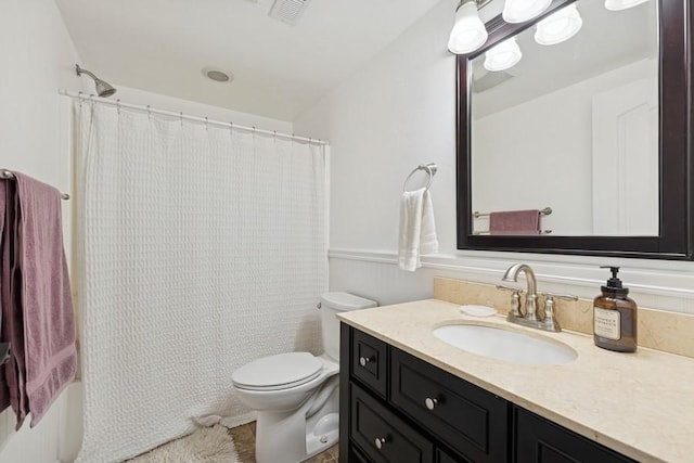 bathroom with vanity, toilet, and visible vents