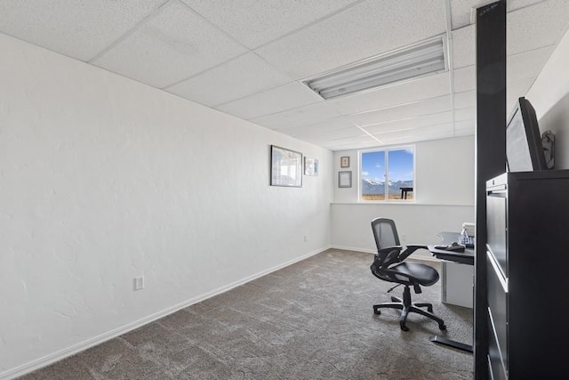 office area with a drop ceiling, baseboards, and carpet floors