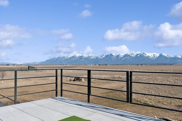 view of patio / terrace with a mountain view and a rural view