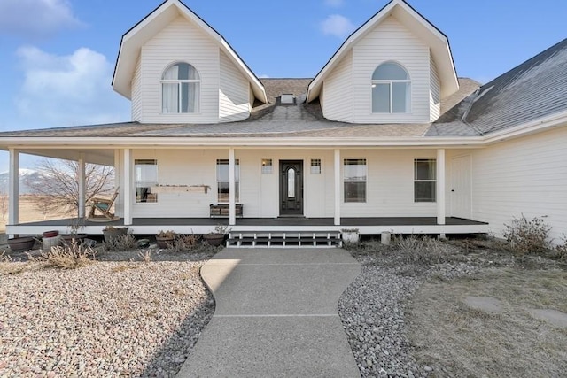 view of front of property featuring a porch and a shingled roof