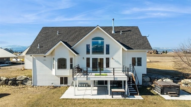 back of house with a patio, stairway, a shingled roof, a wooden deck, and a hot tub