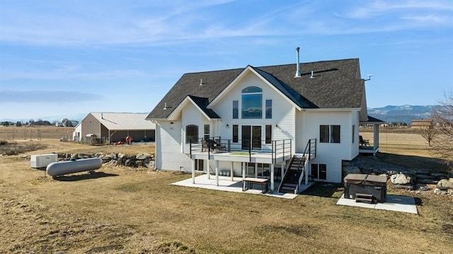 back of property featuring a patio, stairway, a yard, and a wooden deck