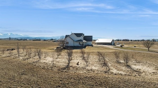 view of yard with a rural view and a mountain view