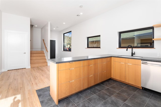 kitchen featuring recessed lighting, a peninsula, stainless steel dishwasher, dark wood-style floors, and a sink