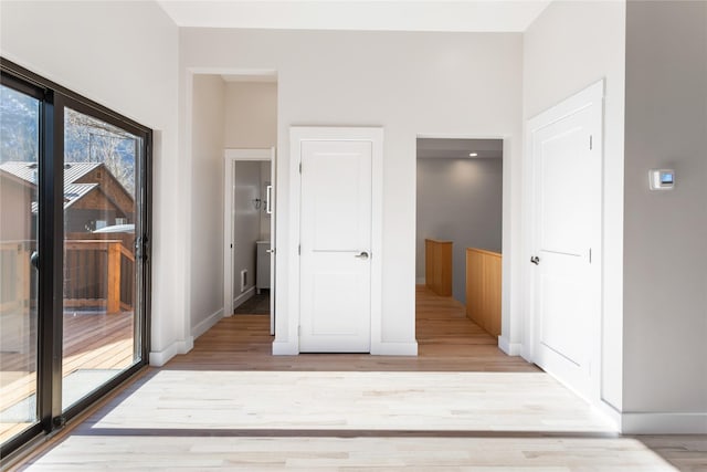 interior space with baseboards and wood finished floors