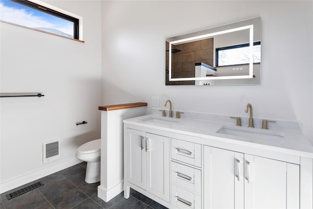 full bathroom with a sink, visible vents, and toilet