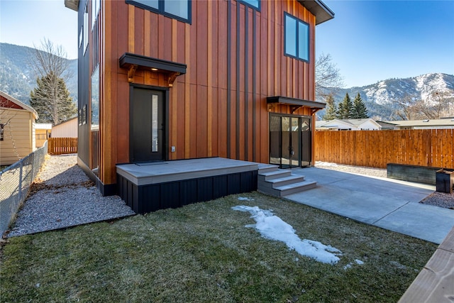 exterior space featuring a mountain view and a fenced backyard