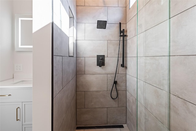 full bathroom with vanity and a tile shower