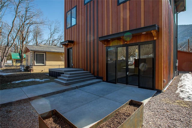 exterior space with a patio and board and batten siding