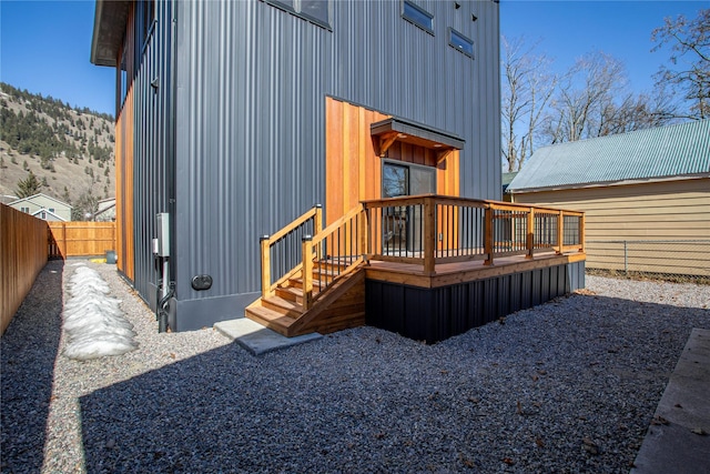 back of house with a fenced backyard and a deck