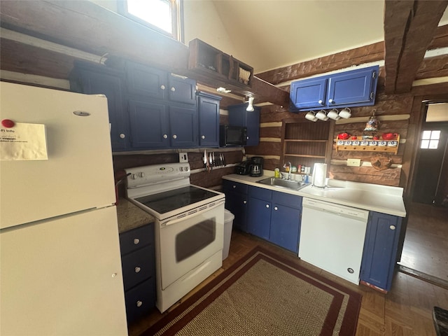 kitchen with a wealth of natural light, white appliances, blue cabinets, and a sink