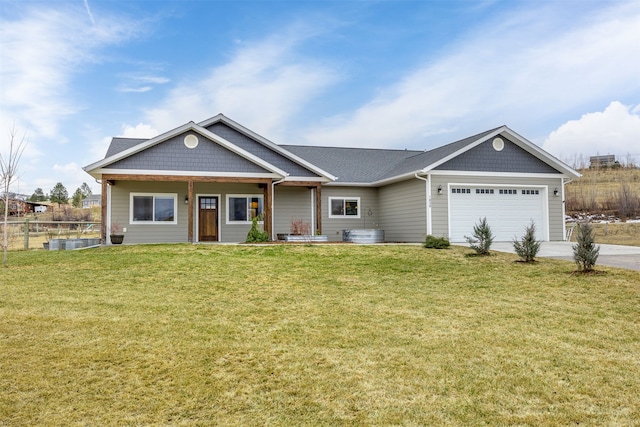 view of front of house featuring a garage, concrete driveway, a front lawn, and fence