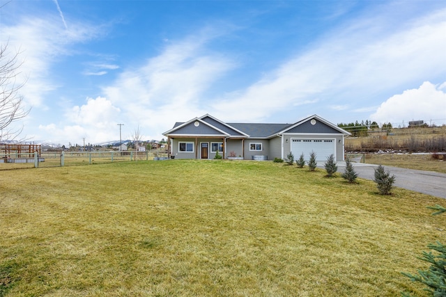 view of front of house with driveway, an attached garage, a front yard, and fence