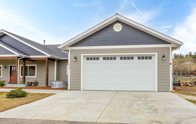 view of front facade with a garage, concrete driveway, and fence