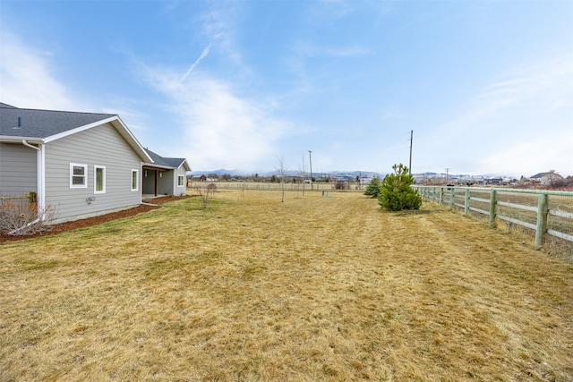 view of yard featuring a rural view and fence