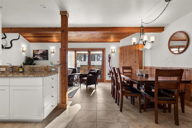 dining room with an inviting chandelier, wooden ceiling, and light tile patterned floors