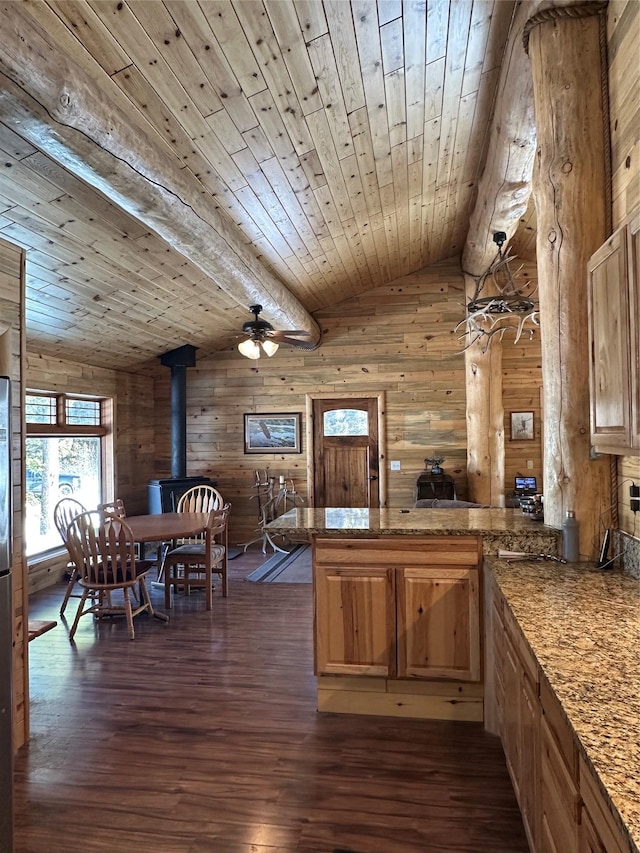 kitchen featuring a ceiling fan, dark wood-style floors, a peninsula, wood ceiling, and vaulted ceiling with beams