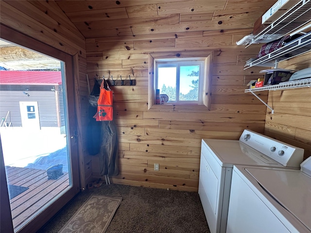 laundry room with laundry area, wooden walls, carpet, and independent washer and dryer