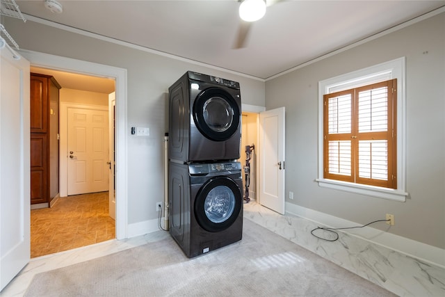 laundry area featuring baseboards, stacked washing maching and dryer, laundry area, ornamental molding, and light carpet