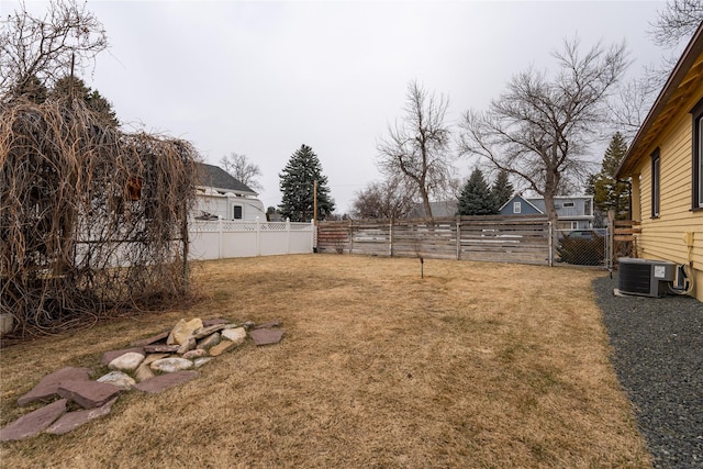 view of yard featuring a fenced backyard and central AC