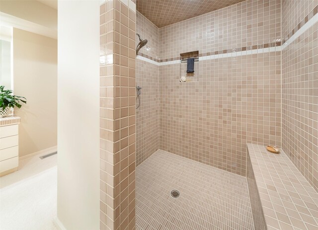 bathroom featuring visible vents and tiled shower